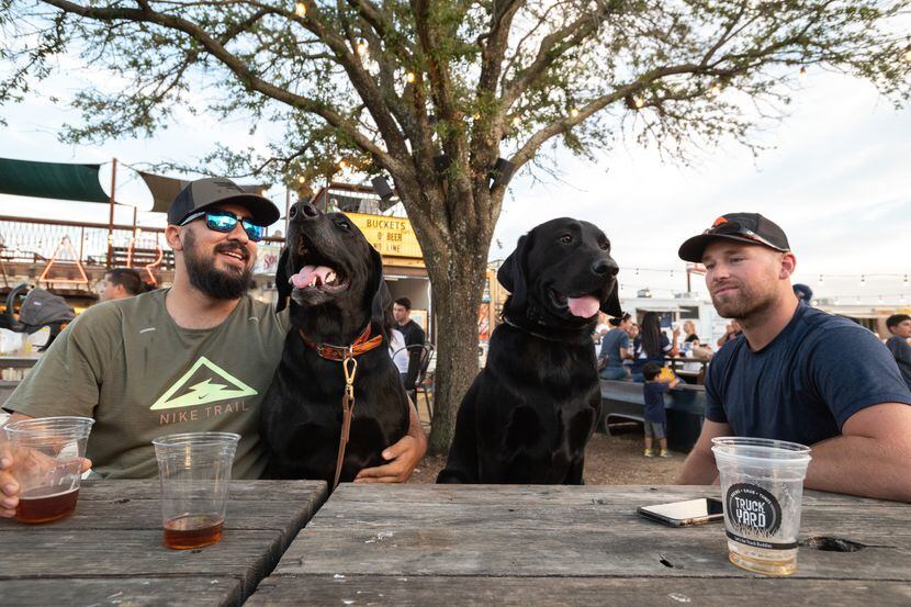 Louis Perez, left, with his dog Goose, and their buddies Bingham and Michael Swayne, have a...