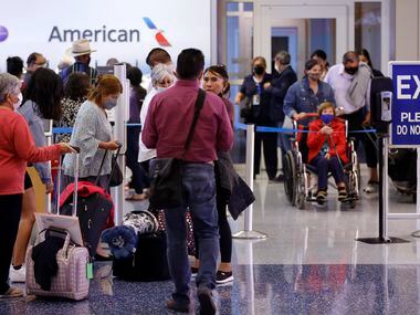 Passengers wait in line to rebook their canceled American Airlines flight in Terminal D at DFW Airport Friday, October 1, 2021. (Tom Fox/The Dallas Morning News)