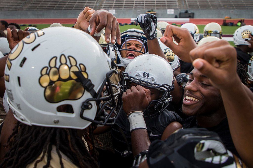 South Oak Cliff players huddle at the start of their season-opening football practice at...