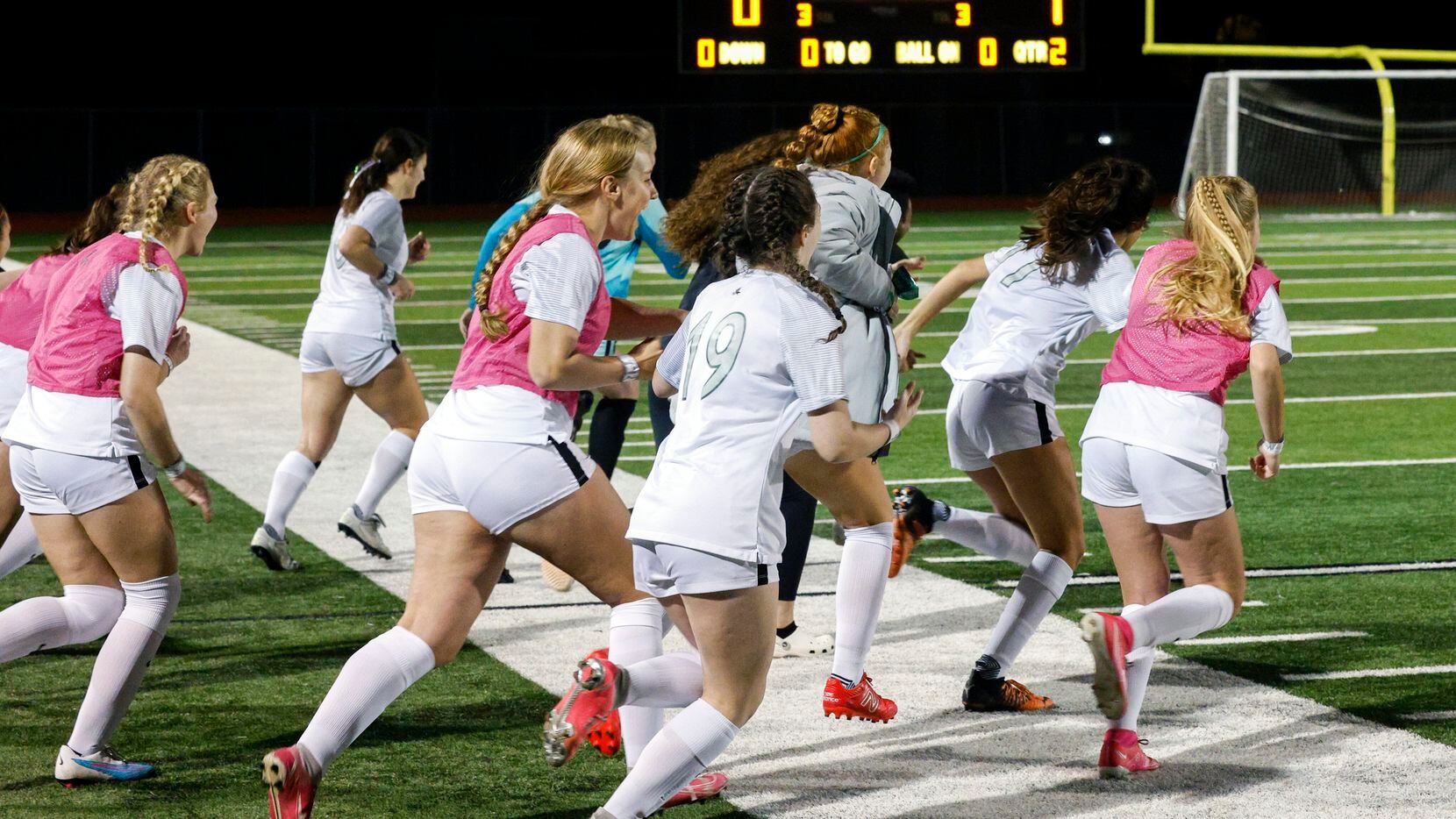Prosper players rush the field after winning a UIL 6A bi-district playoff game against...