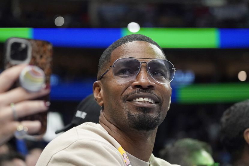 Jamie Foxx smiles during an NBA basketball game between the Washington Wizards and Dallas...