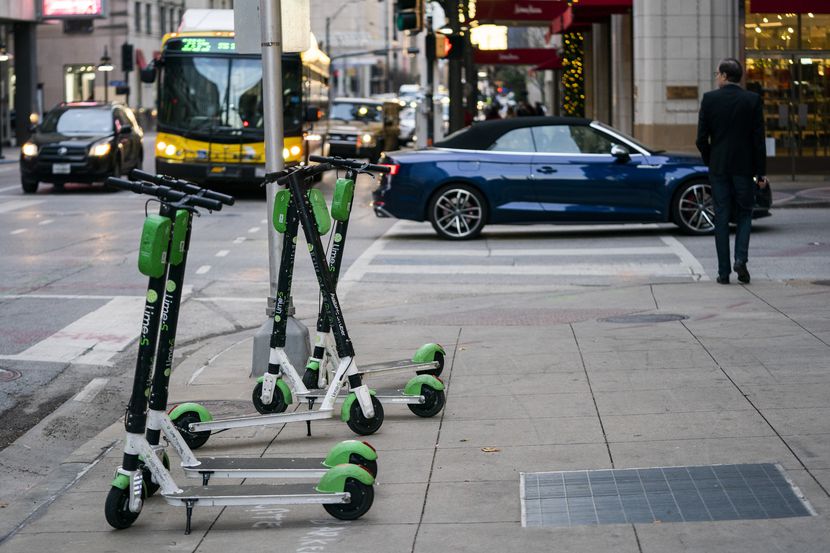 Lime electric scooters sit on the sidewalk on Commerce Street on Wednesday, Dec. 4, 2019 in...