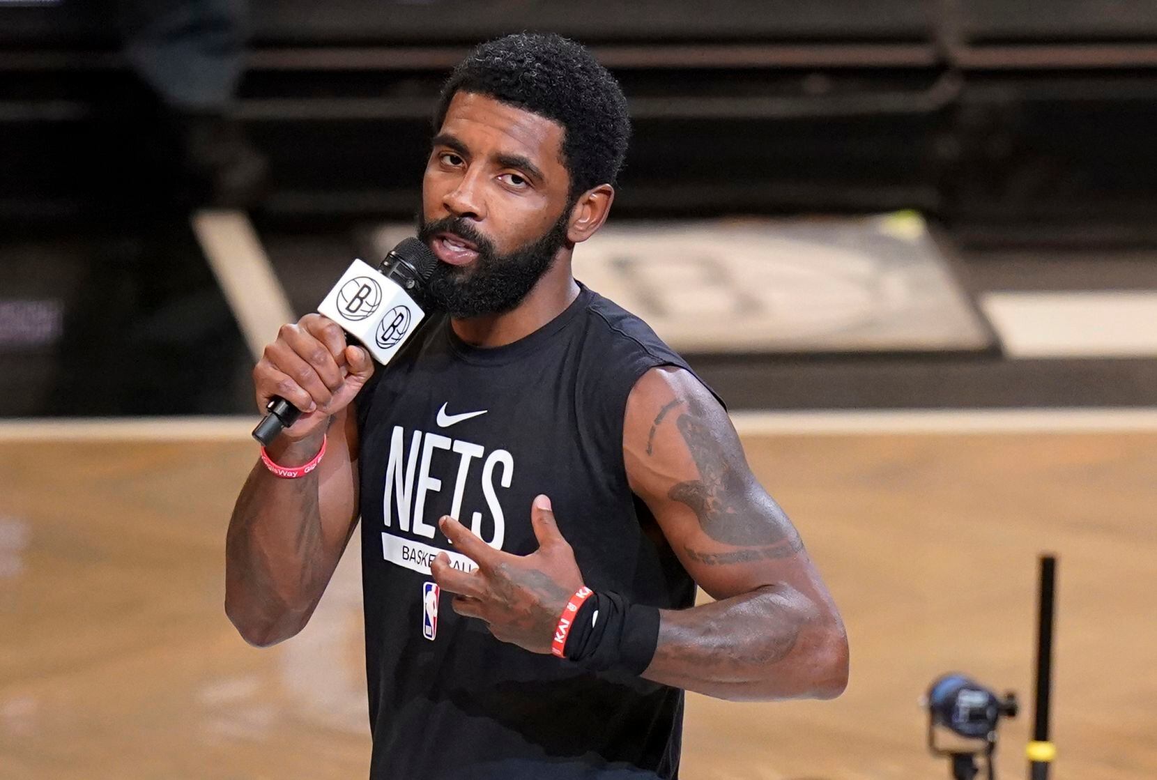 Brooklyn Nets' Kyrie Irving speaks before the team's NBA basketball game against the New...