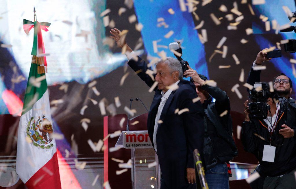 Presidential candidate Andres Manuel Lopez Obrador waves to supporters as he arrives to...