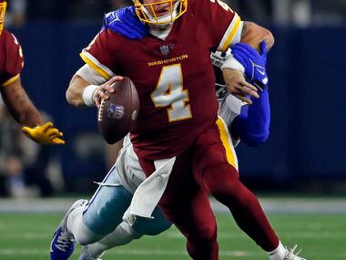 Washington Football Team quarterback Taylor Heinicke (4) is sacked by Dallas Cowboys safety...