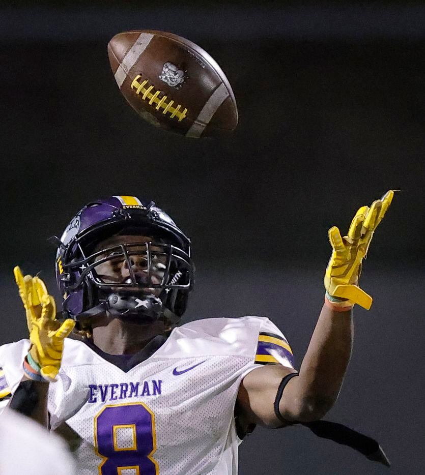 Everman receiver Joanthen Wilson (8) eyes a pass before being hit by South Oak Cliff...