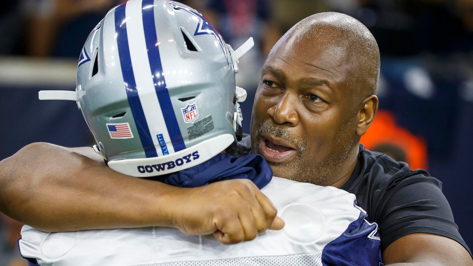 Former Cowboy Charles Haley hugs Dallas Cowboys running back Ezekiel Elliott during the...