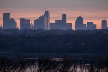 The sun sets behind White Rock Lake and downtown Dallas on Sunday, Feb. 18, 2024.