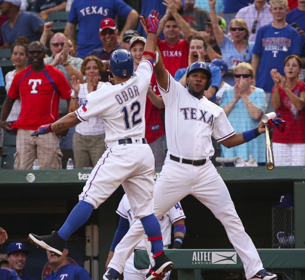 The Texas Rangers' Rougned Odor (12) celebrates his first-inning home run with Elvis Andrus...