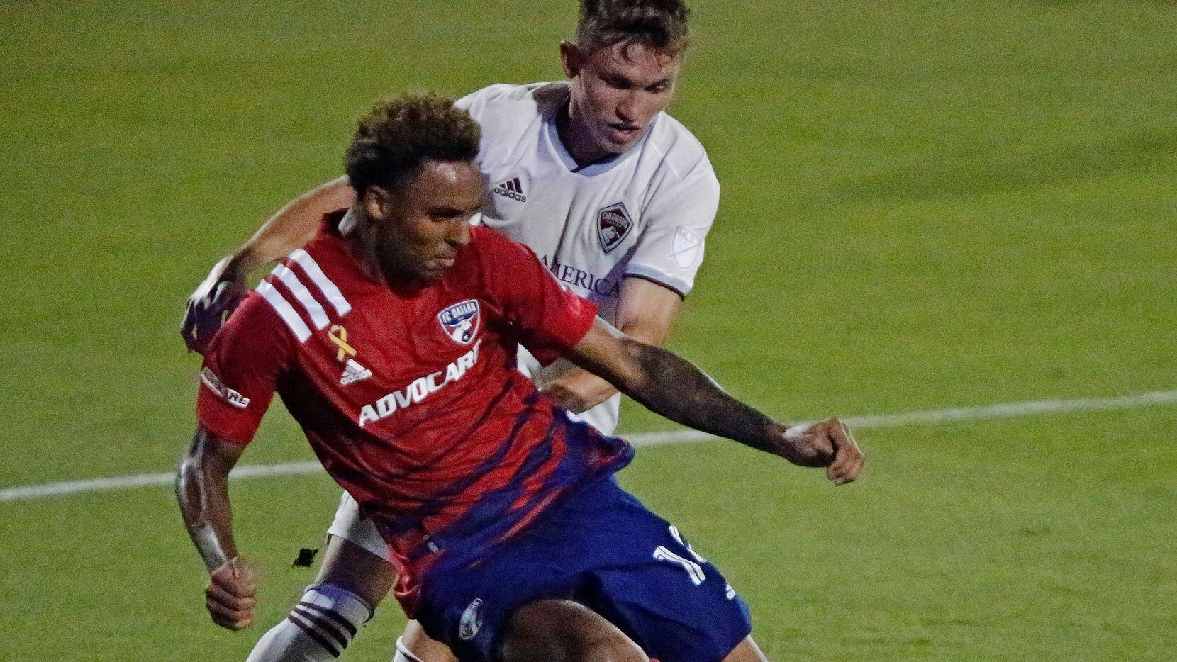 FC Dallas forward Bryan Reynolds (14) leaves his feet as he takes a shot on goal in front of...