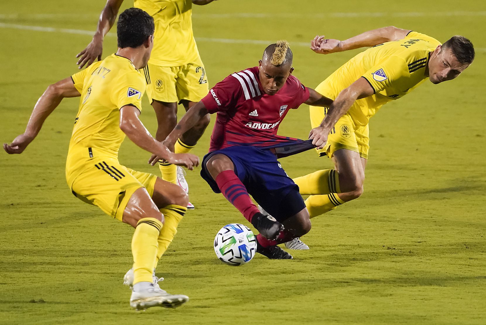 FC Dallas midfielder Michael Barrios (21) has his jersey pulled by Nashville SC defender Dave Romney (4) during the first half of an MLS soccer game at Toyota Stadium on Wednesday, Aug. 12, 2020, in Frisco, Texas. (Smiley N. Pool/The Dallas Morning News)