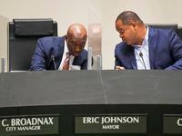 Dallas City Manager T.C. Broadnax and Mayor Eric Johnson confer as they listen to public...