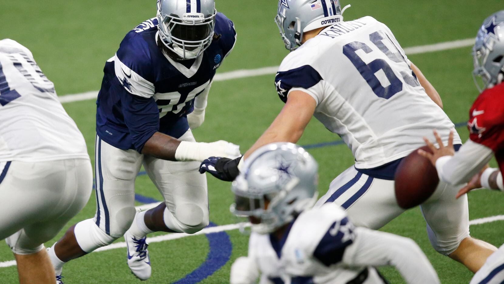 Cowboys defensive end DeMarcus Lawrence (90) rushes against Cowboys offensive tackle Brandon...