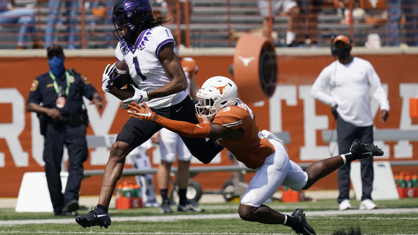 TCU wide receiver Quentin Johnston (1) reaches for a pass over Texas defensive back Jalen Green (3) during the first half of an NCAA college football game, Saturday, Oct. 3, 2020, in Austin, Texas. Johnston was tripped up on the play and dropped the ball.