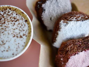 A vanilla latte and an order of Le Boneignets with strawberry, classic and chocolate powder,...