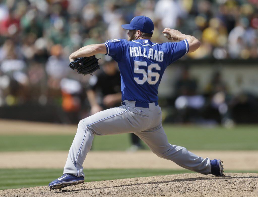 Kansas City Royals' Greg Holland works against the Oakland Athletics in the ninth inning of...