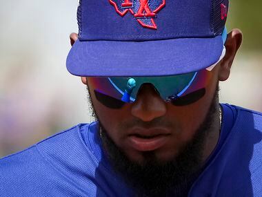 Texas Rangers shortstop Yonny Hernandez heads for the dugout between innings of a spring...