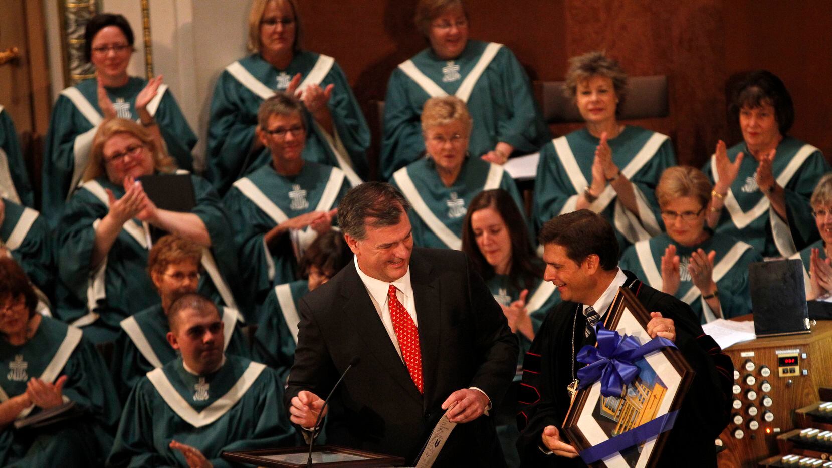 In this file photo, the Rev. Joe Clifford presents Dallas Mayor Mike Rawlings with a framed...