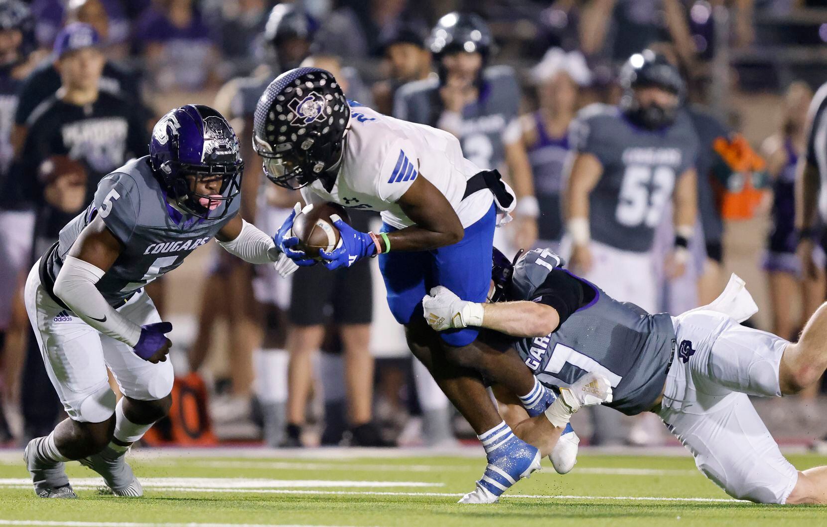 Mansfield Summit wide receiver Kerya Powell (2) is pulled down by College Station defensive...