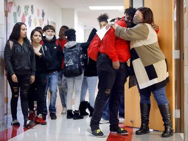 Terrell ISD Superintendent Georgeanne Warnock (right) gives a hug to Cedrick Taylor after he...