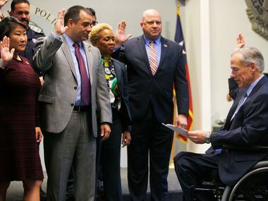 Greg Abbott swears in new board members of the Dallas Police Association before Tuesday's...