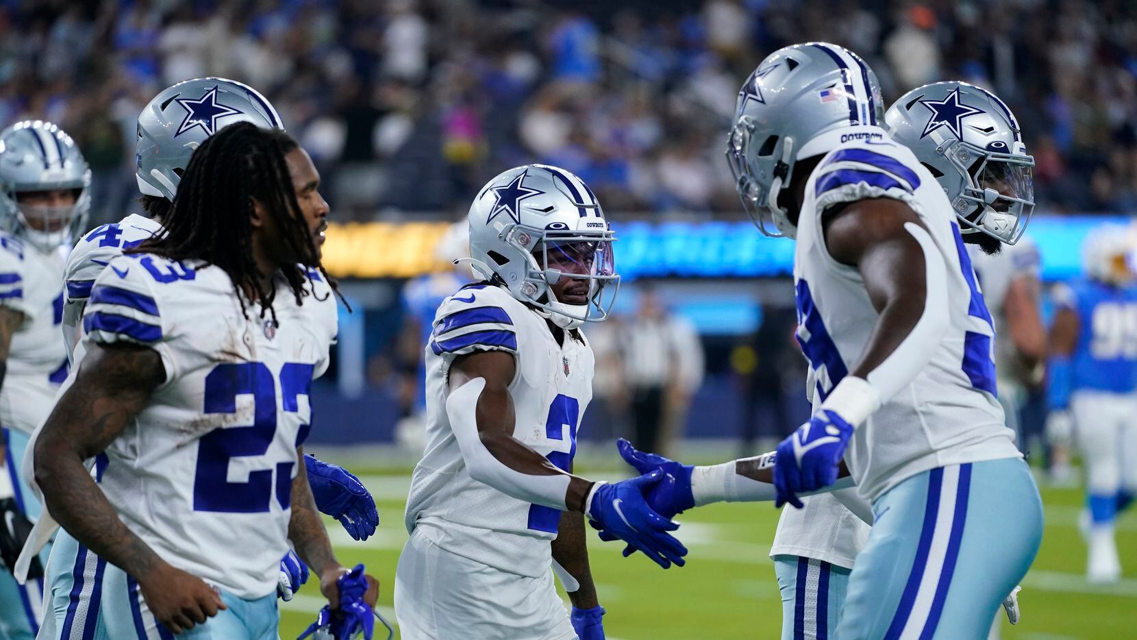 Dallas Cowboys' KaVontae Turpin, center, shakes hands with teammates after returning a punt...