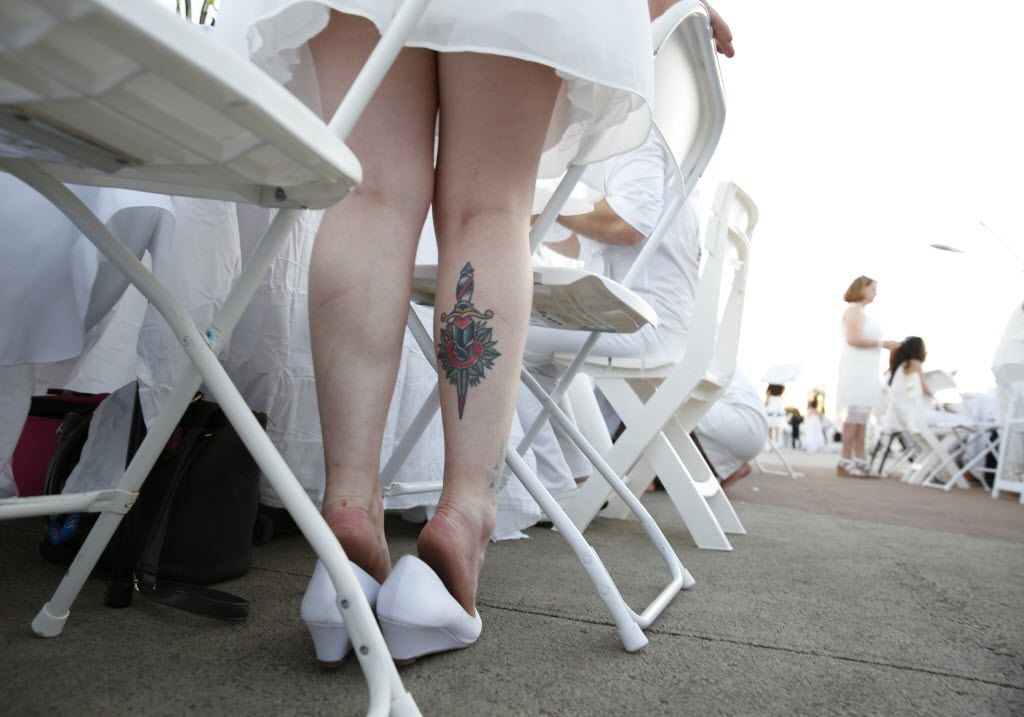 Brittany Caramanna waits by her table during the inaugural Diner en Blanc Dallas on the...