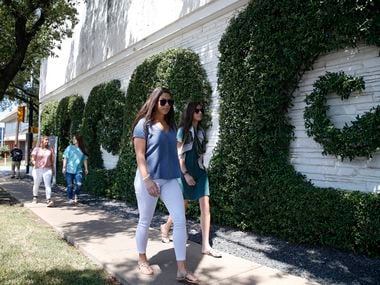 Sara Salvatierra (left) and Simone Henderson walk around the Simpli.fi building in Fort Worth.