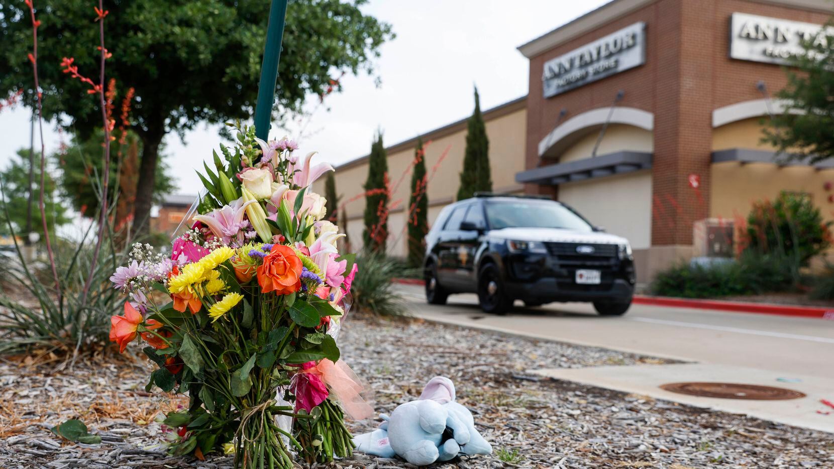 Flower bouquets remains at a makeshift memorial outside of Allen Premium Outlets mall, a day...