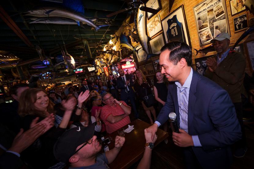 Presidential candidate Julian Castro shakes hands with supporters during a campaign event at...