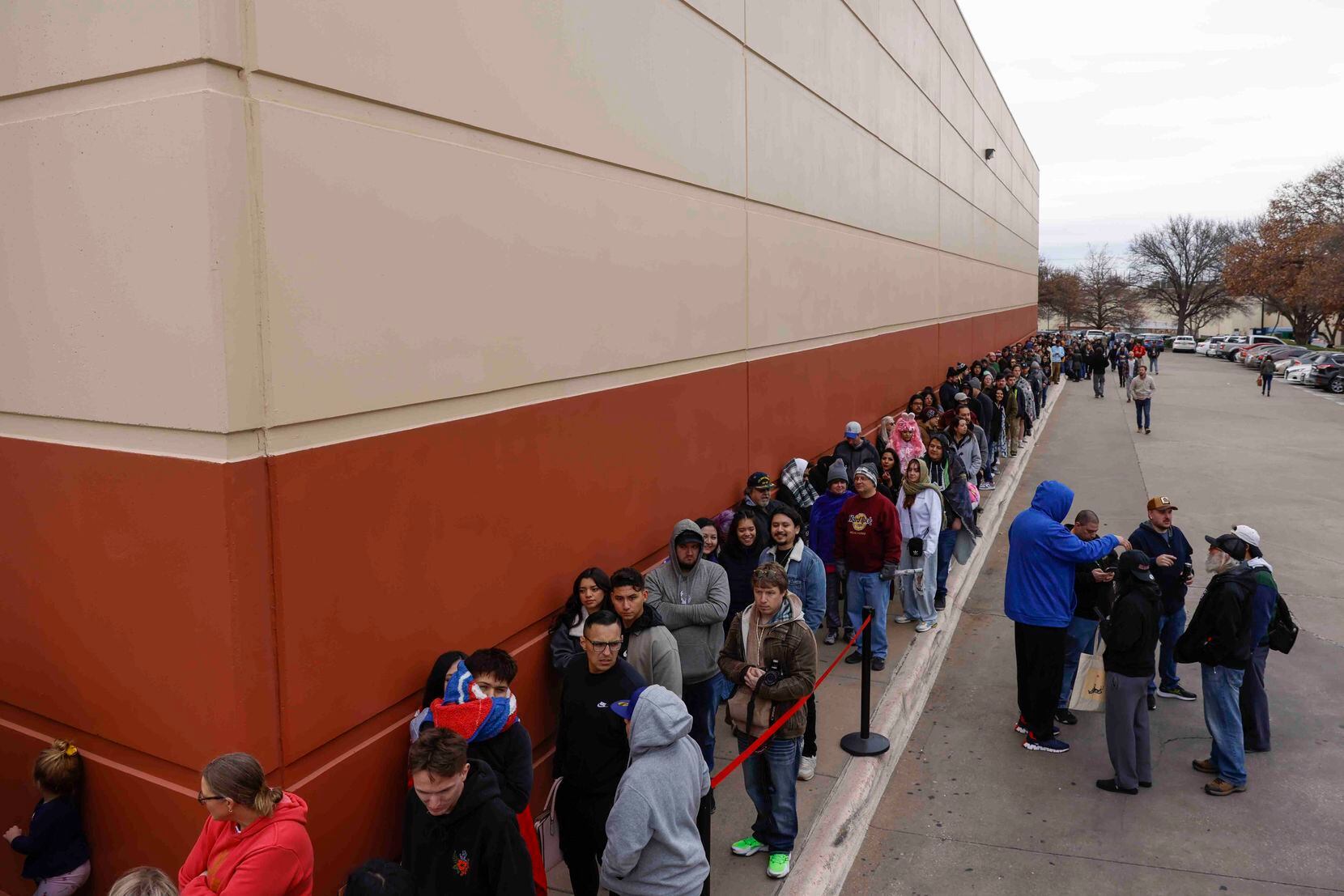 Hundreds of people wait in line to get a glimpse of actors Bryan Cranston and Aaron Paul. 