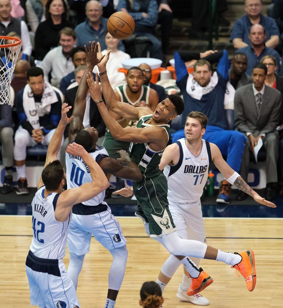 Milwaukee Bucks forward Giannis Antetokounmpo (34) drives to the basket as Dallas Mavericks forward Maximilian Kleber (42), forward Dorian Finney-Smith (10) and forward Luka Doncic (77) defend during the first half of an NBA basketball game at American Airlines Center on Friday, Feb. 8, 2019, in Dallas. (Smiley N. Pool/The Dallas Morning News)