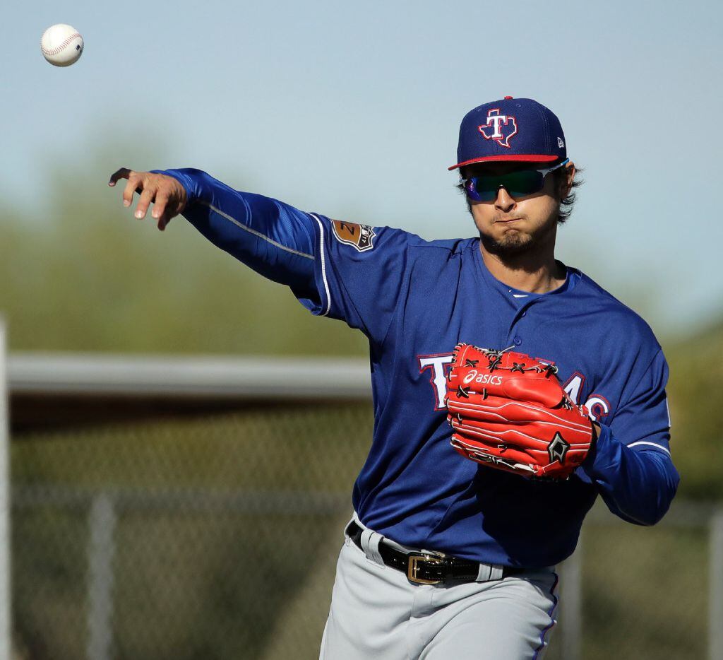 Texas Rangers pitcher Yu Darvish throws during spring training baseball practice Thursday,...