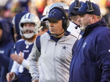 Dallas Cowboys offensive coordinator Kellen Moore and head coach Mike McCarthy work on the sidelines during the first half of an NFL football game against the Washington Football Team on Sunday, Dec. 12, 2021, in Landover, Md.