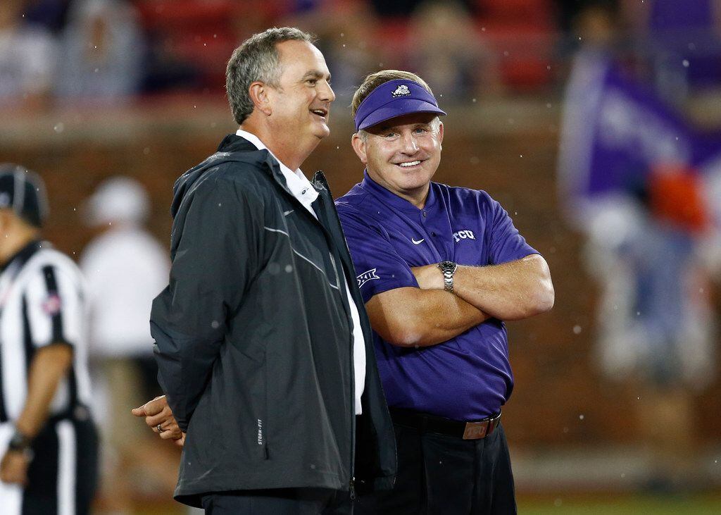 TCU coach Gary Patterson, right, and SMU coach Sonny Dykes, left, talk before an NCAA...