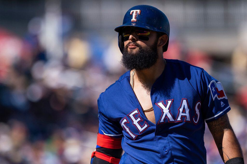 Texas Rangers second baseman Rougned Odor heads back to the dugout after being called out on...