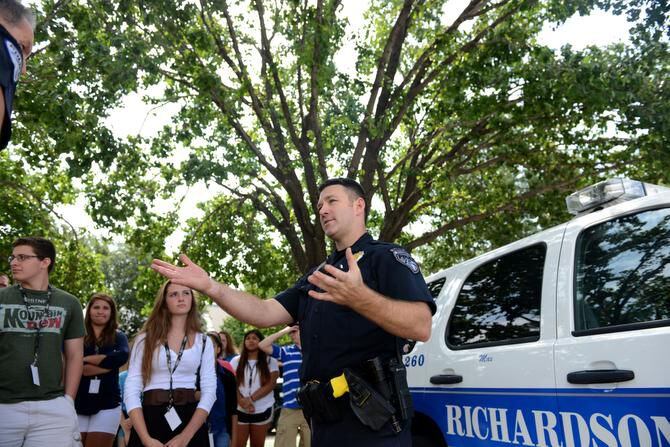Richardson Police officer Cory Wendling speaks to students during a K-9 unit demonstration...