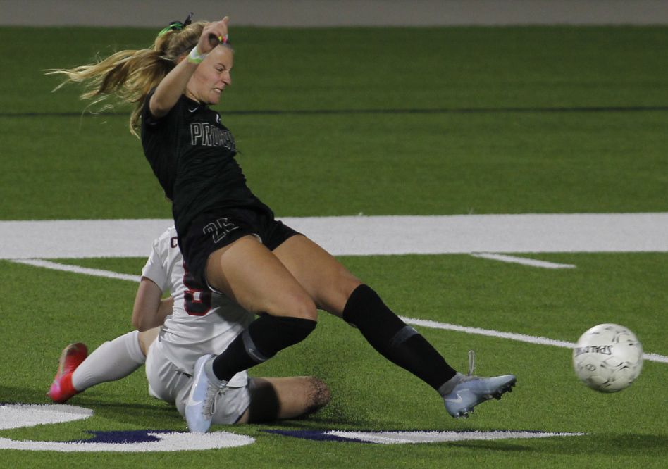Prosper's Lola Gregory (26) grimaces as she collides with Coppell's Sadie Ozymy (5) yet...