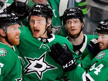 Dallas Stars center Roope Hintz (24) is congratulated on his first period goal by teammates...