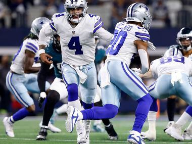 Dallas Cowboys quarterback Dak Prescott (4) hands the ball off to running back Tony Pollard...