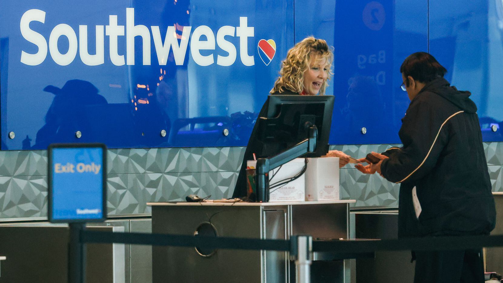 Southwest Airlines worker assists customers at Dallas Love Field airport in Dallas on...
