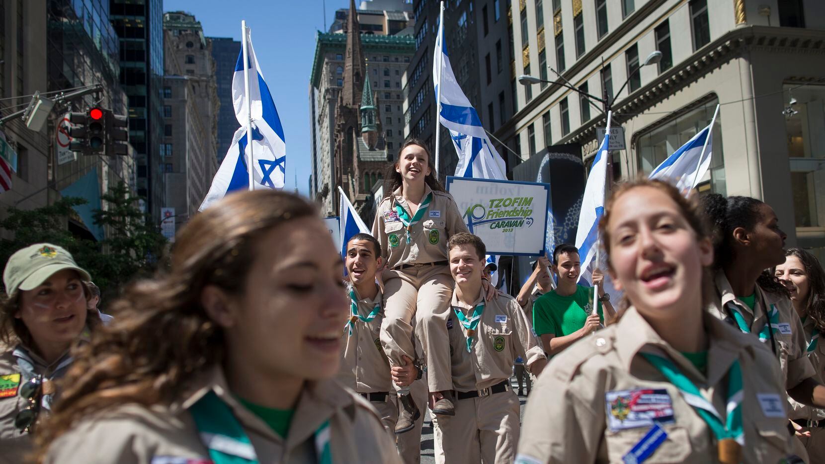 Revelers from the TZOFIM Friendship caravan march up Fifth avenue during the Celebrate...