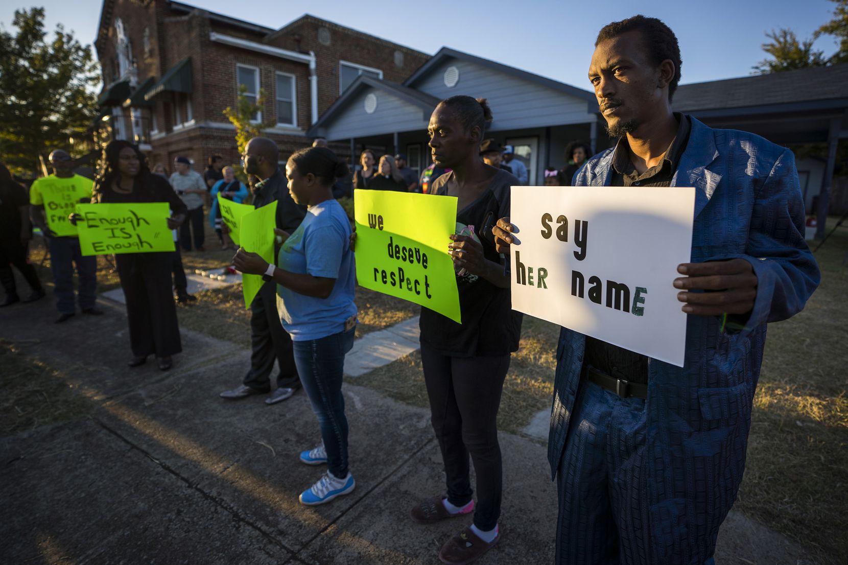 Protestors gather outside the house (right) where Atatiana Jefferson was shot and killed, during a community vigil for Jefferson on Sunday, Oct. 13, 2019, in Fort Worth, Texas.  Jefferson, a 28-year-old black woman, was shot in her home by a white Fort Worth police officer during a welfare check.