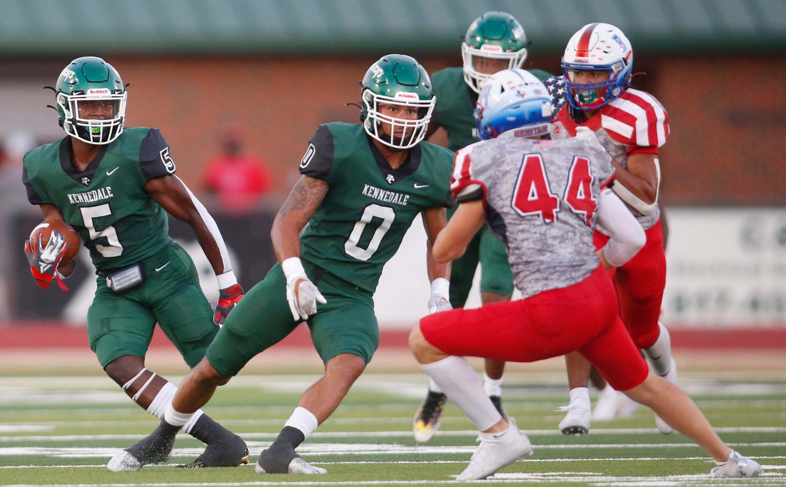 Kennedale punt returner Tyler Choice (5), left, cuts outside of a block from teammate Braden...
