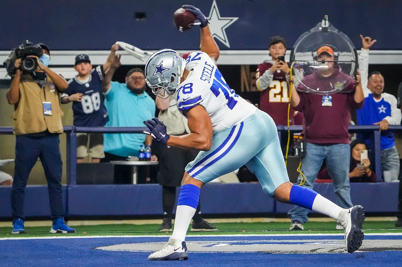 Dallas Cowboys offensive tackle Terence Steele (78) spikes the ball after scoring on a 1-yard touchdown reception during the first half of an NFL football game against the Washington Football Team at AT&T Stadium on Sunday, Dec. 26, 2021, in Arlington.