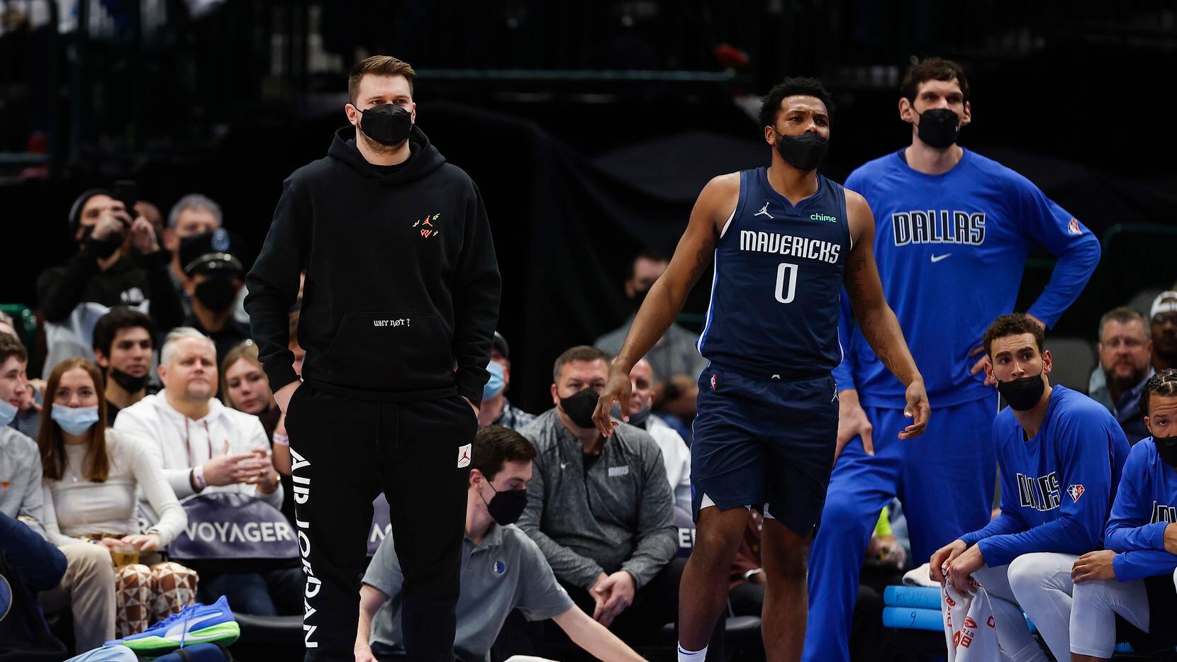 Dallas Mavericks guard Luka Doncic, left, and forward Sterling Brown (0) look on from the...