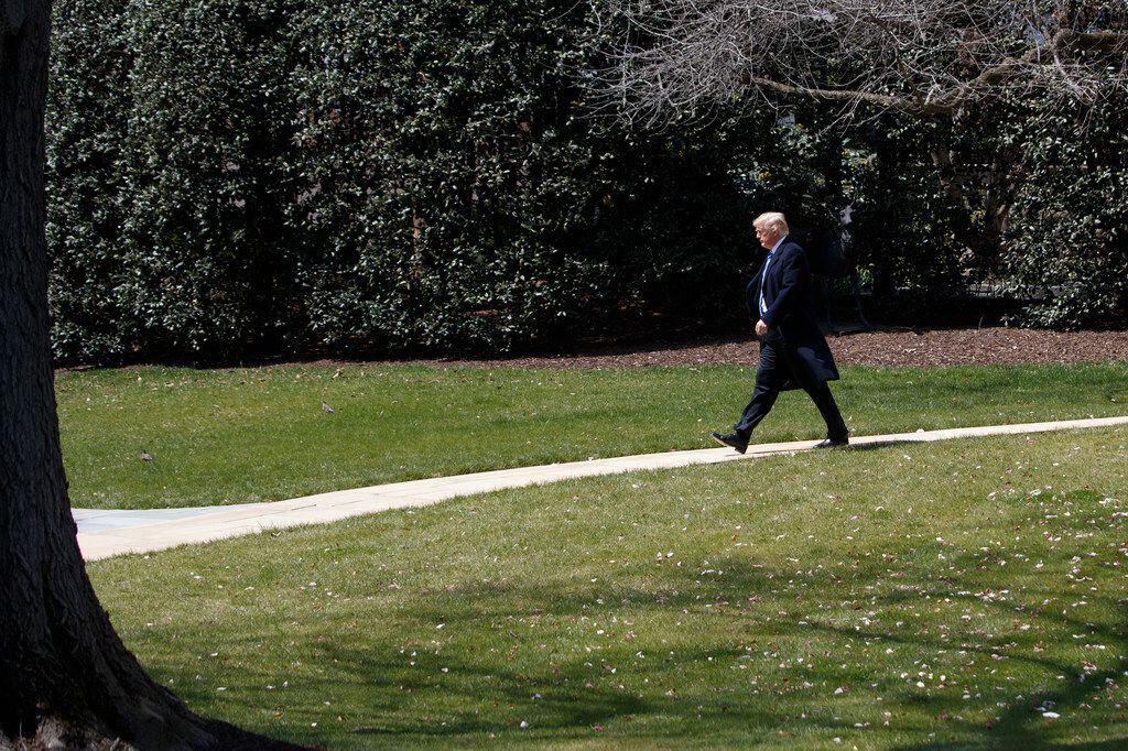 President Donald Trump walks from the Oval Office to Marine One at the White House in...