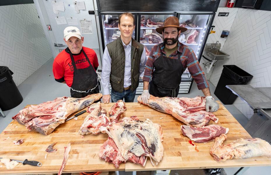 Jeff Cutshall, center, owner of Custom Meats, opened the shop with employees Chris Ward,...