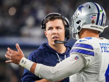 Dallas Cowboys offensive coordinator Kellen Moore talks with quarterback Dak Prescott during...