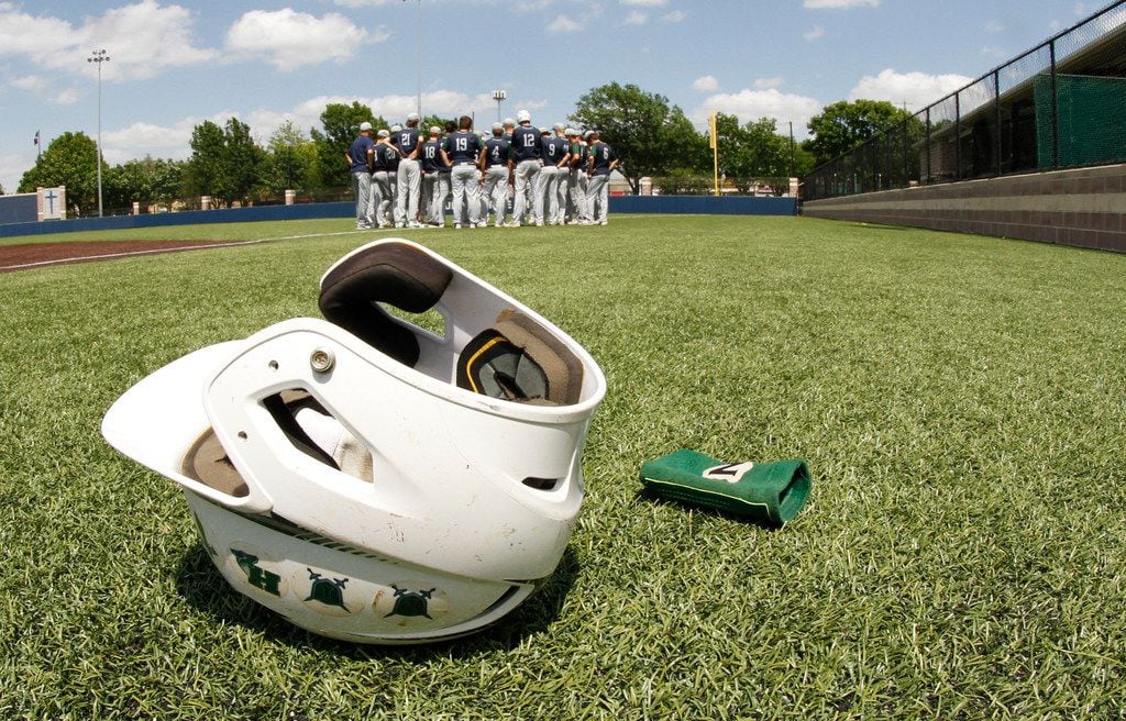 A batting helmet lays on the turf following Frisco Reedy's season ending loss 10-3 in Game 2...
